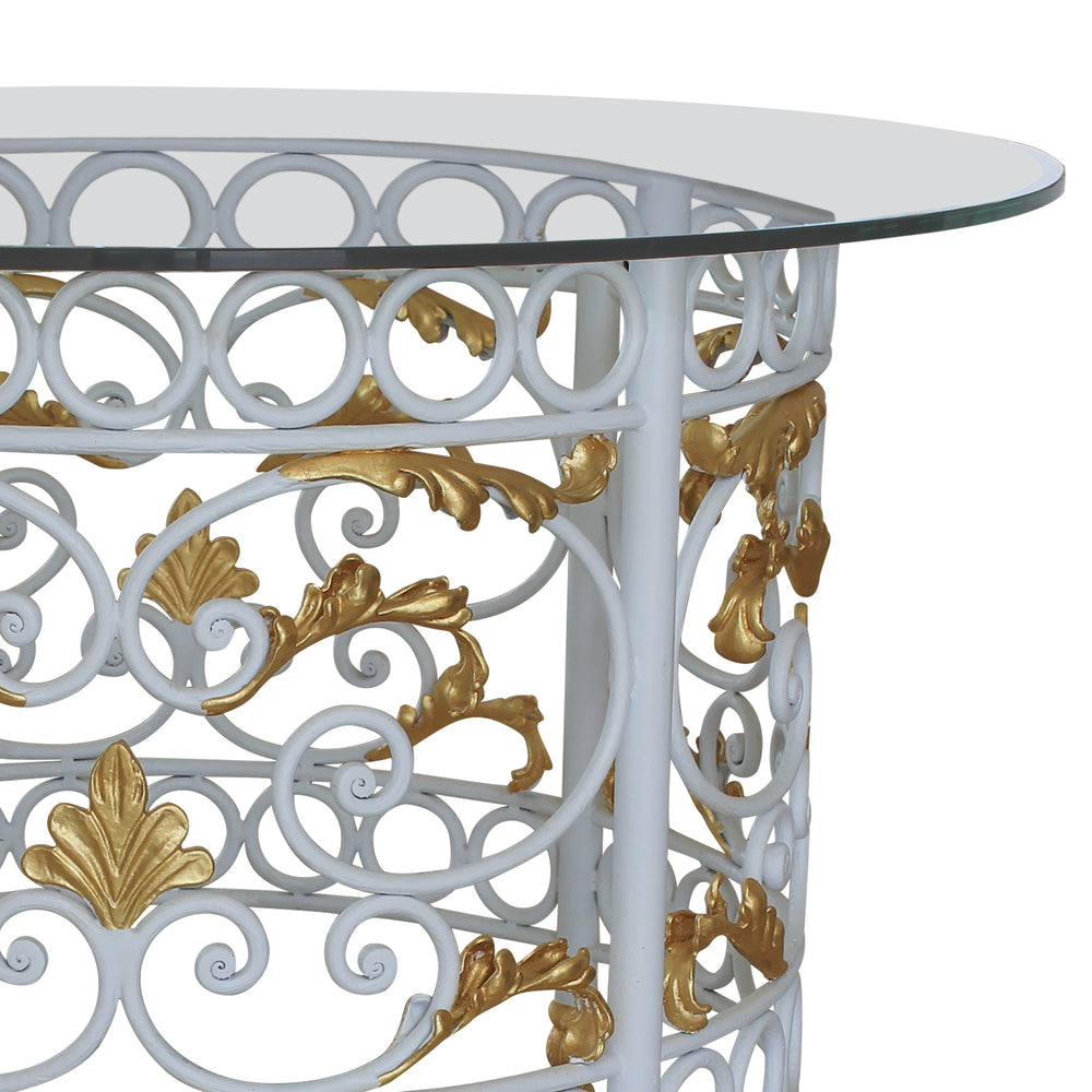 Close up of a classical wrought iron entry table with scrolls and leaves painted in a white and golden finish