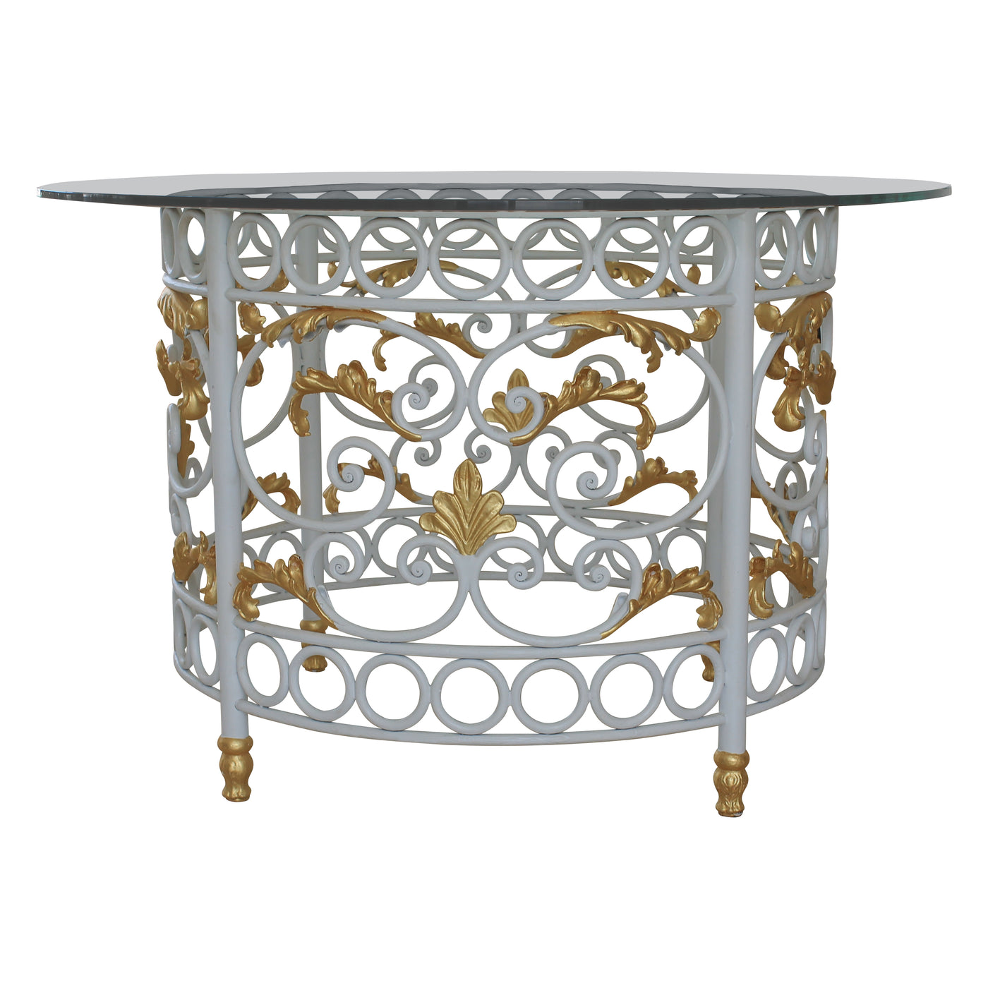 A round lobby table with a classical wrought iron base with white scrolls and golden leaves, topped with a clear circular glass