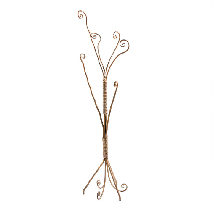 A unique organic clothes hanger stand with arms made of metal forged scrolls, painted in an antique bronze finish