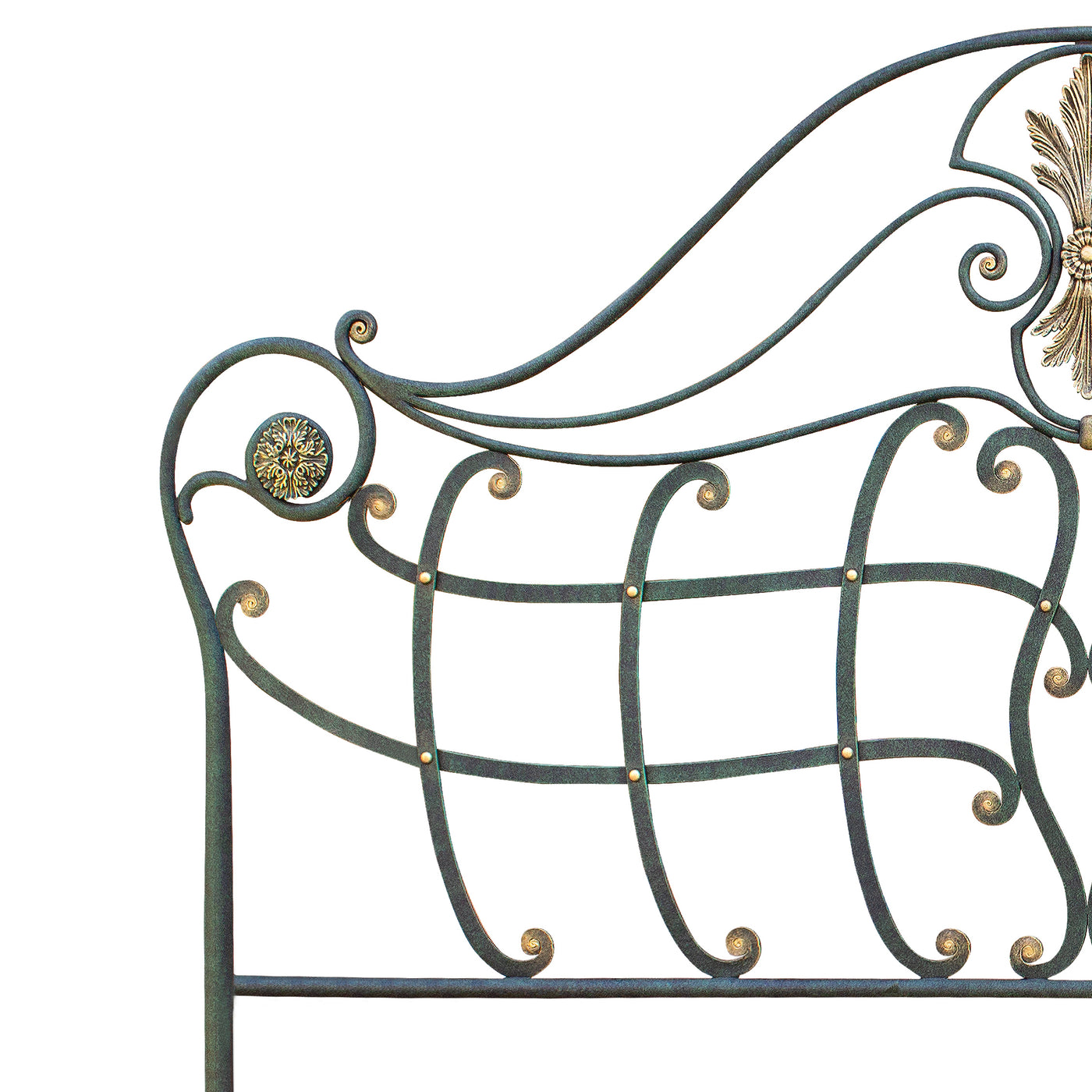 Close up of a classical metal headboard with handmade scrolls painted in an antique green and golden finish