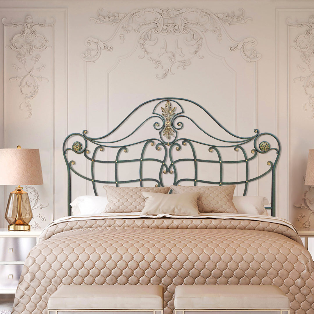 A classical wrought iron double bed with a luxurious pink bedding set, painted in an antique green and gold finish