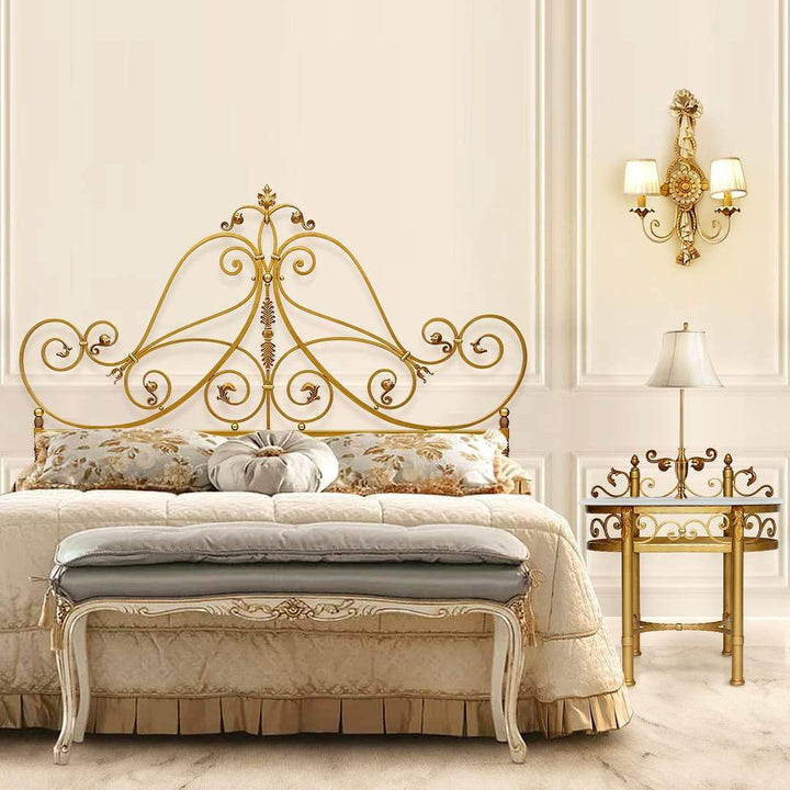A classical wrought iron bedroom set painted in an antique gold finish