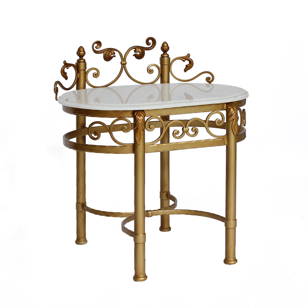 A classical wrought iron nightstand painted in antique gold and topped with marble