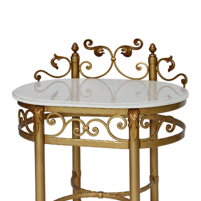 Close up of a classical night table painted in an antique gold finish