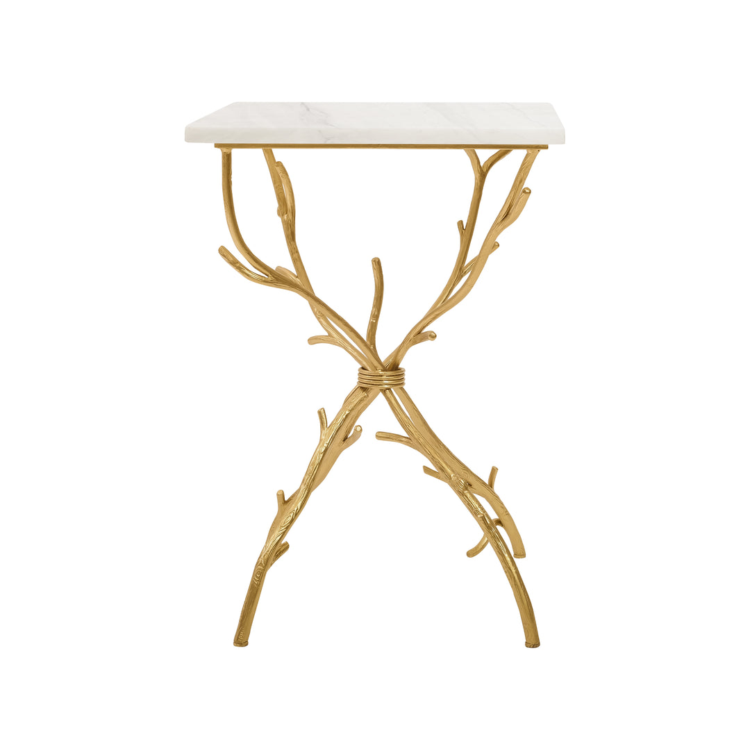 A trendy side table with golden legs that resemble branches topped with a white piece of marble