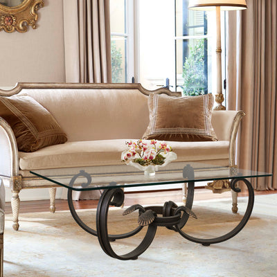 A contemporary wrought iron coffee table inspired by seashells topped with glass in a luxurious living room