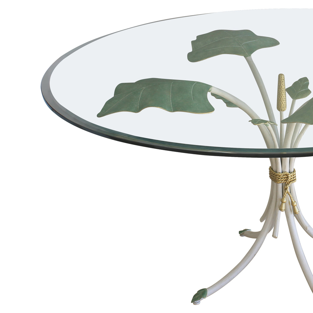 Close up of a unique nature-inspired iron round lobby table with leaves and stems painted in green and white