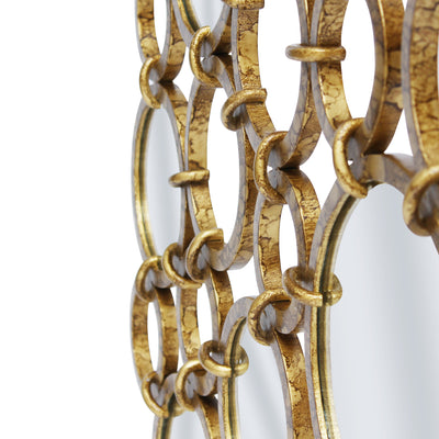 Close up shot of a contemporary mirror made up of adjacent rings in an antique gold finish
