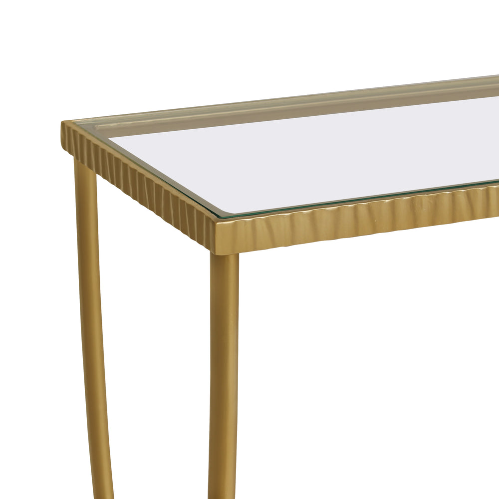Close up of unique styled console table with simple golden curved legs and a clear glass top