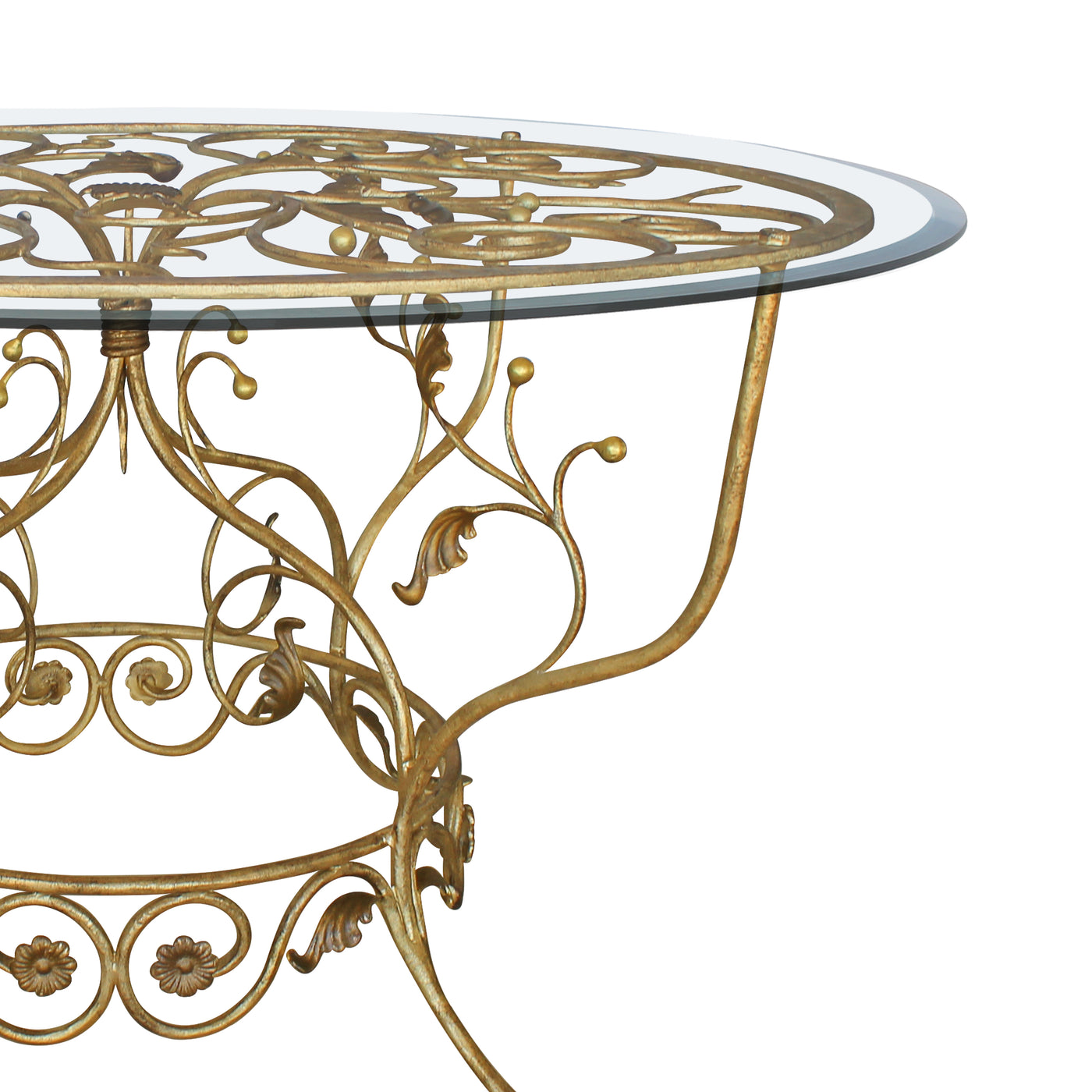 Close up of a classical wrought iron entryway table with scrolls and leaves painted in an antique golden finish