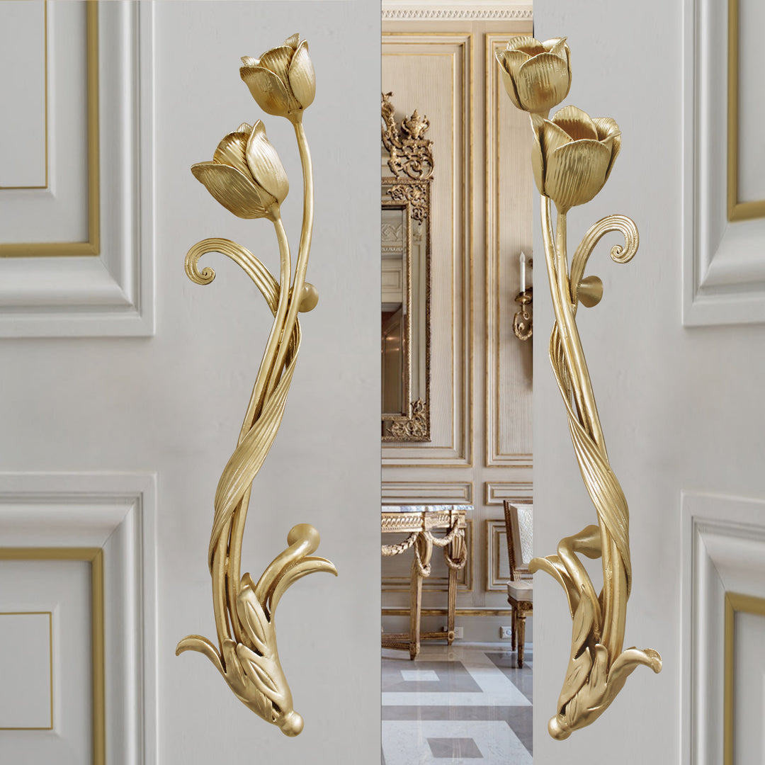 Pair of golden decorative pull handles inspired by tulips mounted on an open wooden door
