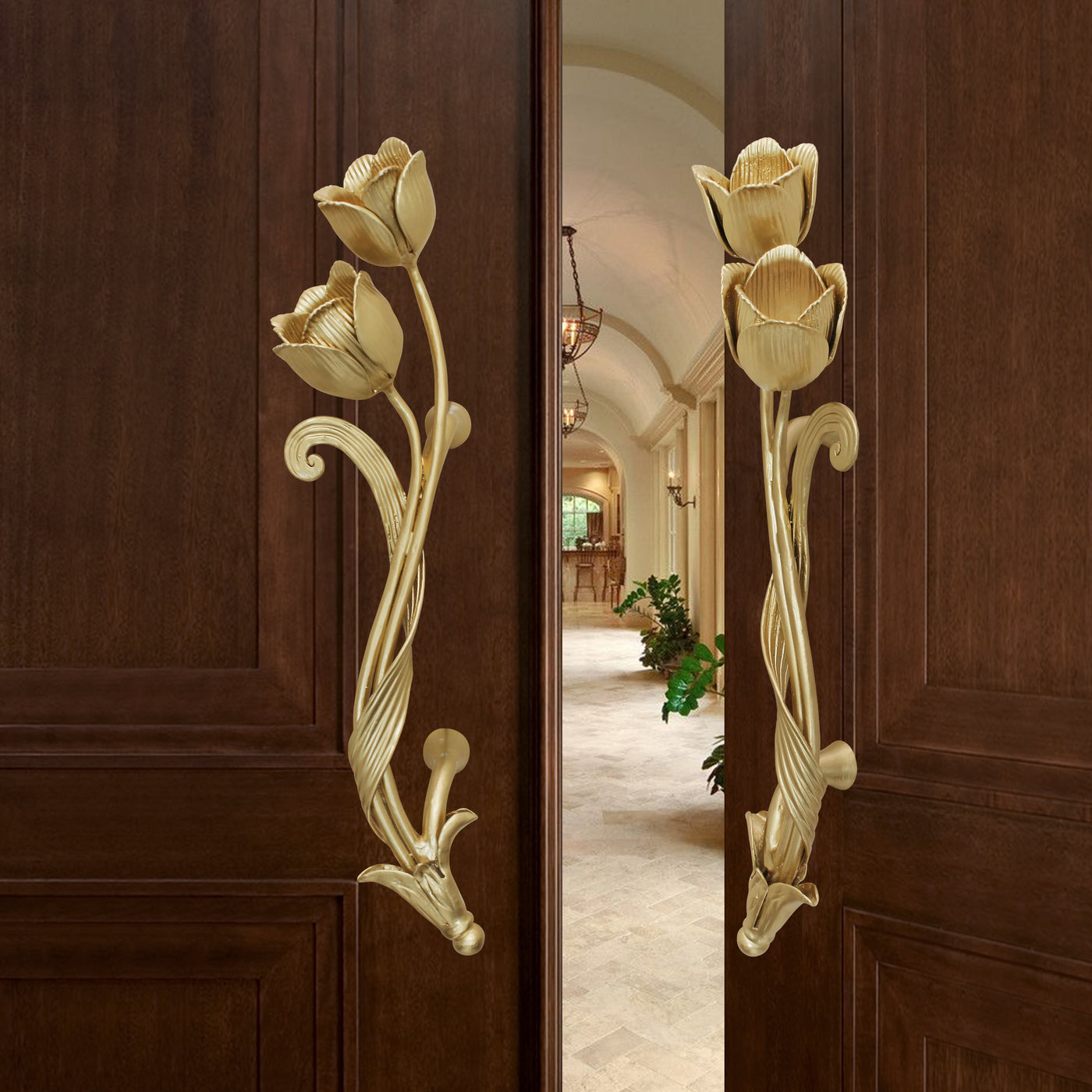 Pair of golden decorative pull handles inspired by tulips mounted on an open wooden door