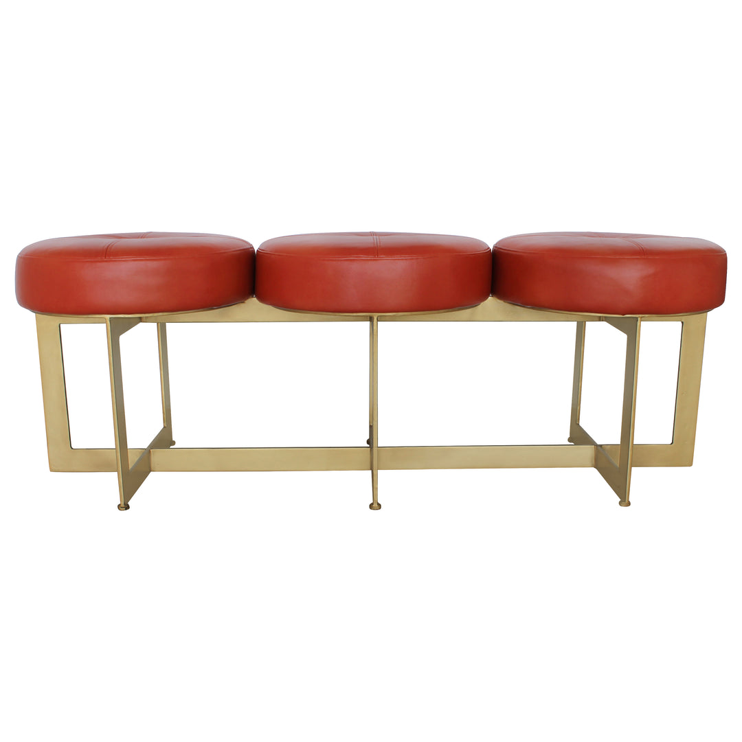Modern bench with a metal gold base topped with red leather upholstery