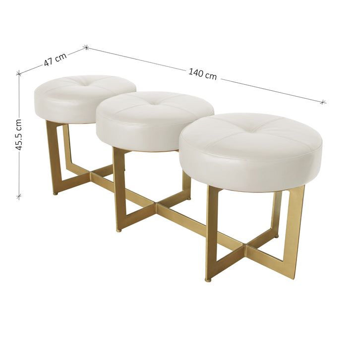A modern metal golden bench topped with three round cushions upholstered in white leather; with annotated dimensions