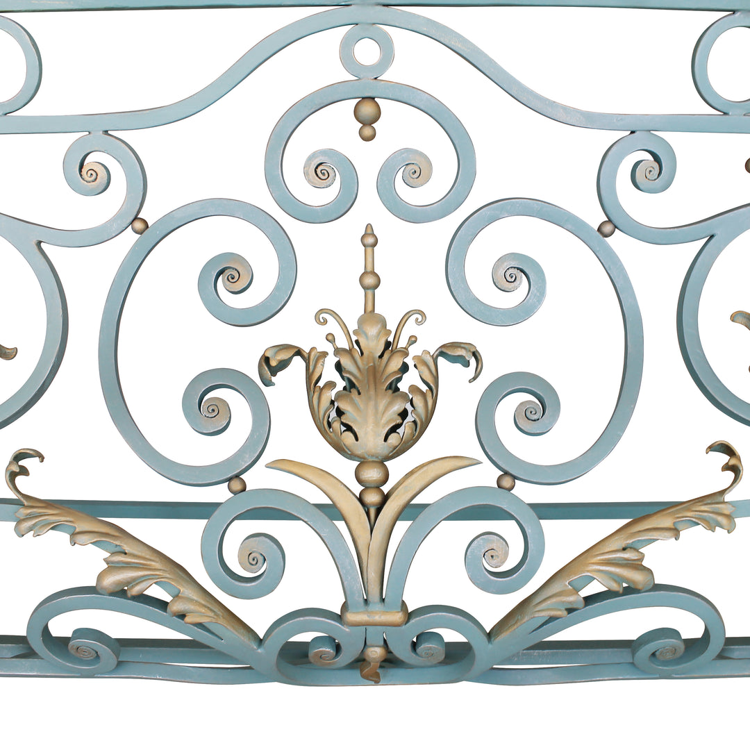 Close up of a classical console base made up of blue wrought iron scrolls and golden leaves