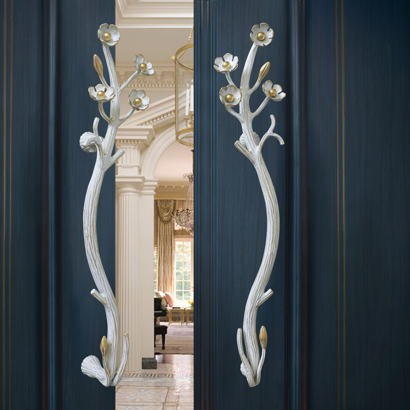 A pair of luxury steel handles with nature inspired branches and flowers mounted on a door