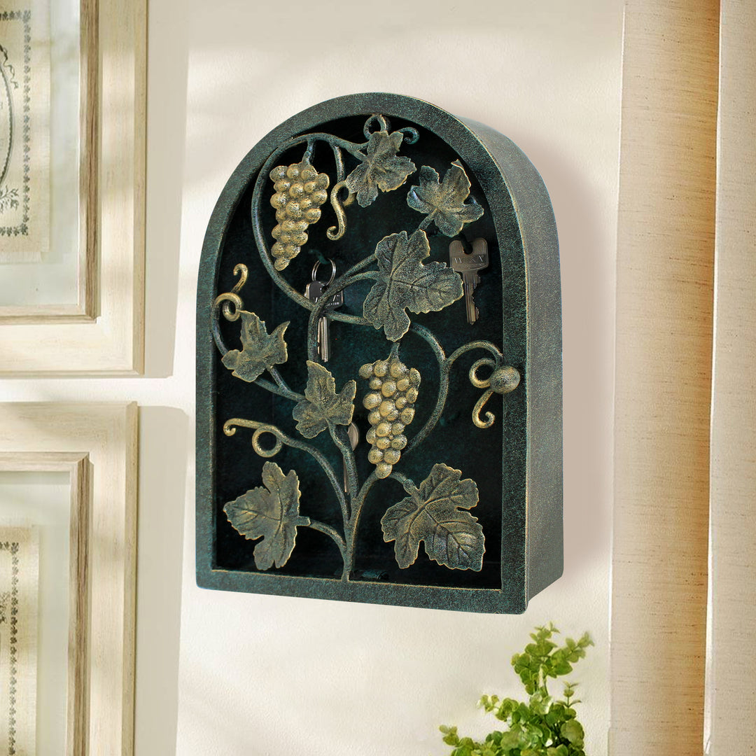 Side view of arched rustic key cabinet inspired from grape vines painted in antique green